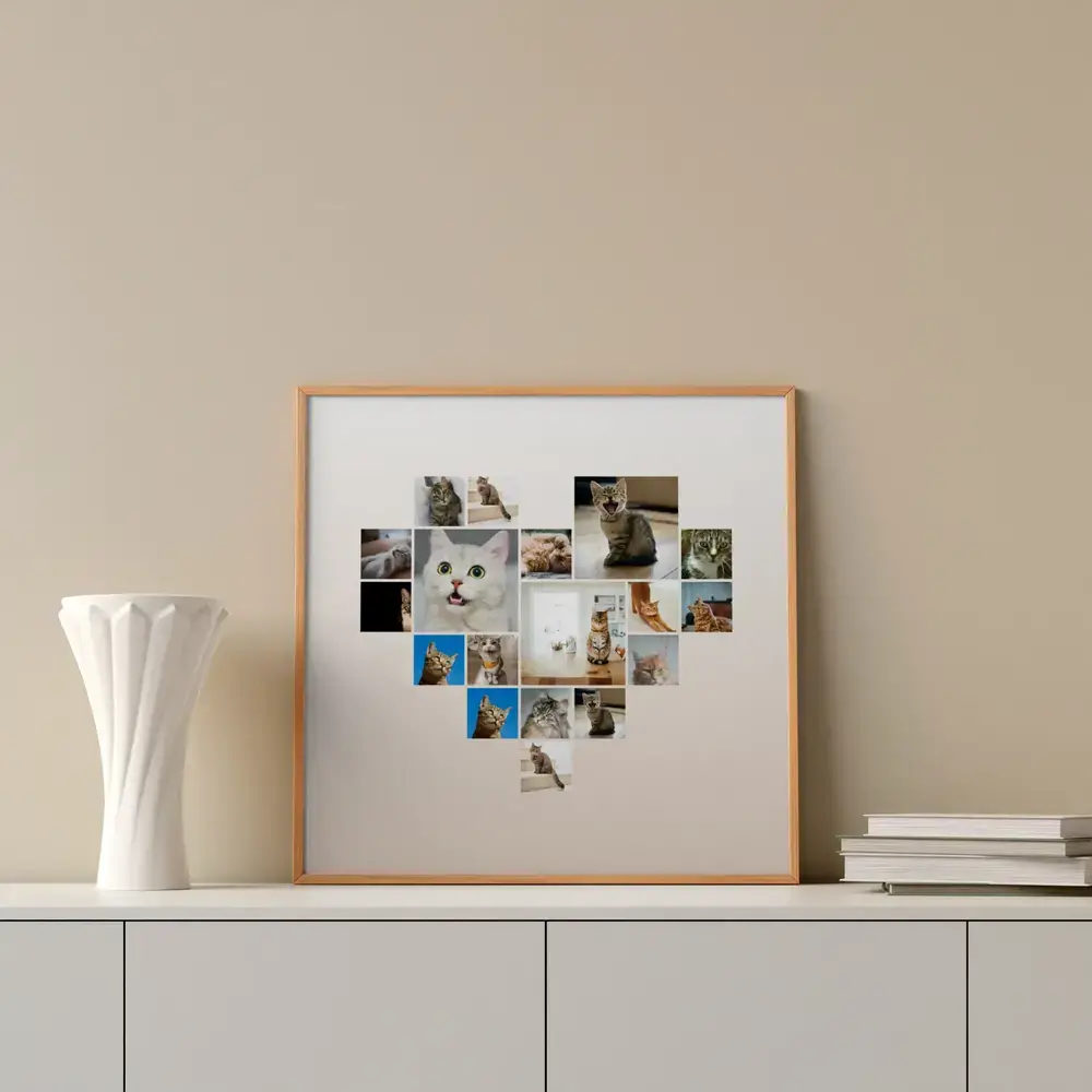 Herzförmige Katzen-Fotocollage im Naturholzrahmen auf einem Sideboard neben weißer Vase und Büchern