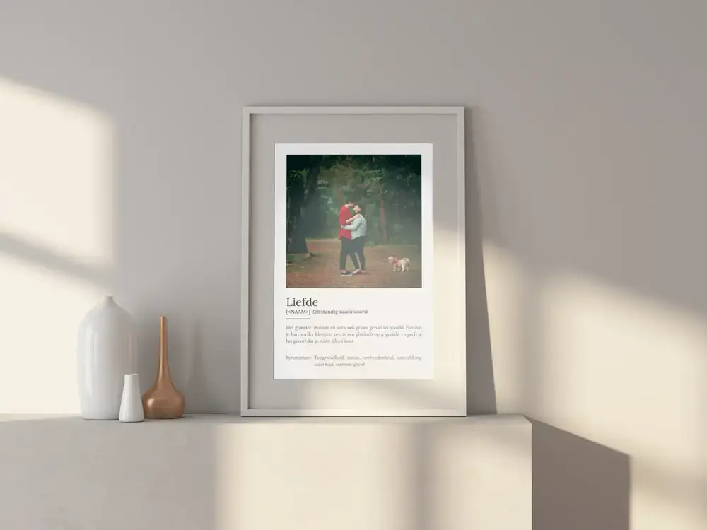 Liefdesposter met bosfoto in witte lijst op een dressoir met vazen, als romantisch cadeau voor een trouwdag
