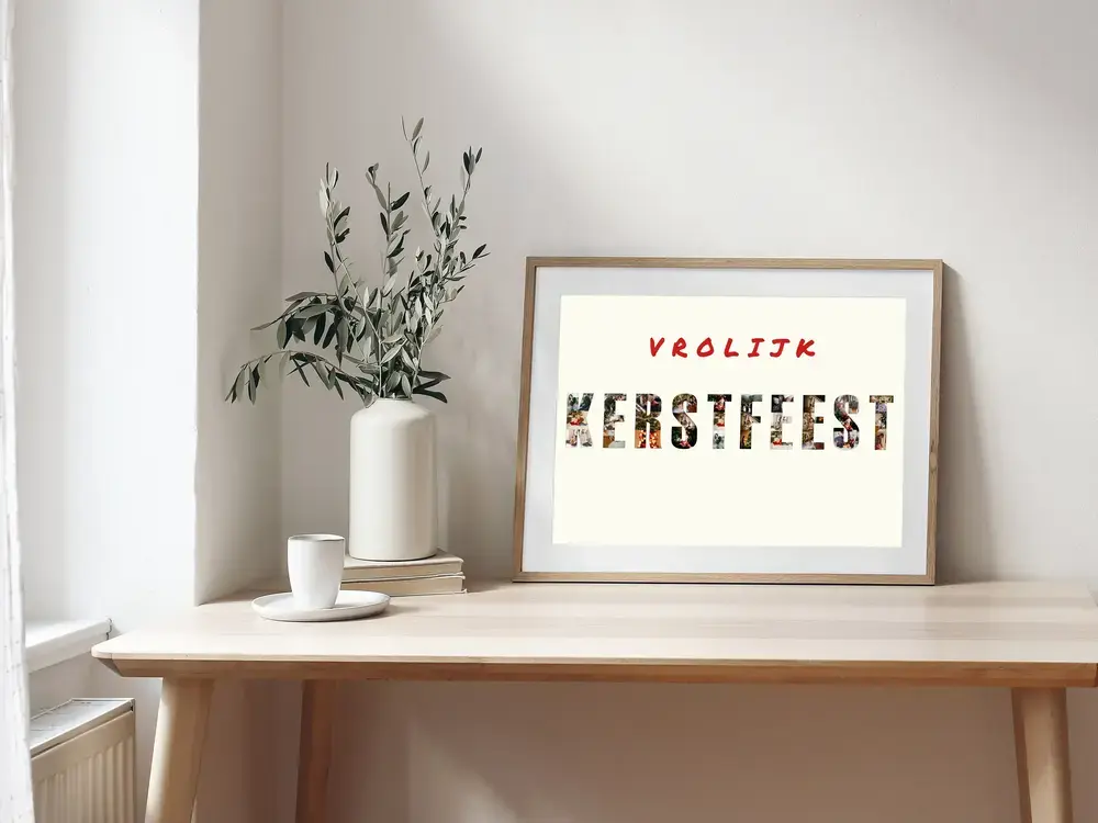 Kerstfotocollage met letters gevuld met familiefoto’s in een houten lijst, op een bureau naast een vaas